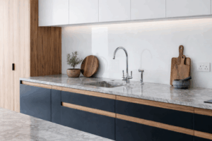 Clear glass splashback installed behind a kitchen sink and worktop