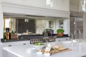 Mirror splashback installed behind a range cooker in a country style kitchen
