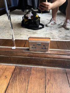 Precision cut mirror fitted neatly around floor socket