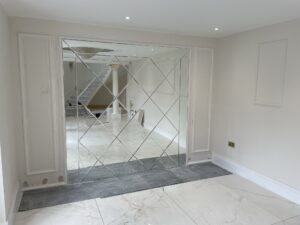 Decorative mirrored feature wall with diamond pattern panels