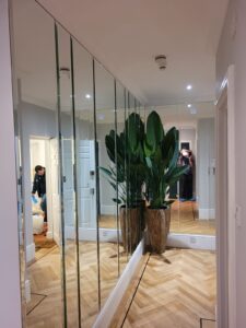 Hallway mirrored wall panels in a residential interior