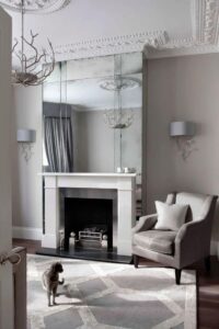 Large feature mirror above fireplace in a traditional living room