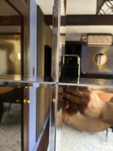 Close-up of mirrored wall panel alignment showing precise joints and clean edges